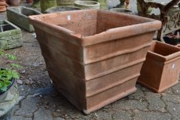 A very large square shaped terracotta plant pot (rim damaged).
