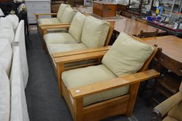 In the manner of Gustav Stickley, an oak framed three piece lounge suite comprising pair of two