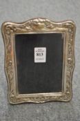 An embossed silver photograph frame.