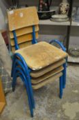 A set of four childrens stacking chairs.