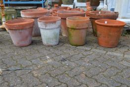 Four large terracotta plant pots.