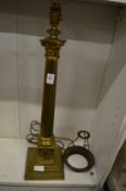 A brass corinthian column table lamp.