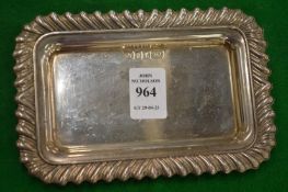 A small rectangular silver tray with gadrooned border.