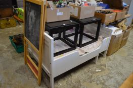 An Ikea cot and a childs chalk board.