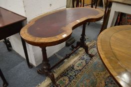 A Victorian walnut and leather inset kidney shaped writing table.