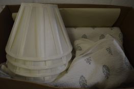 An Oka throw and set of four pleated lamp shades.