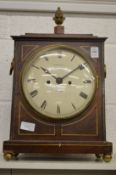 A Regency brass inlaid mahogany bracket clock with pineapple finial, the circular dial signed Thomas