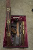 A box of old wood working squares and levels.