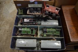 A small collections of 'O' gauge clockwork trains and carriages.