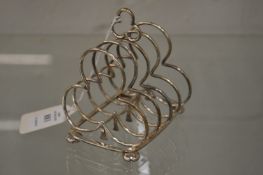 A silver four division trefoil shaped toast rack.