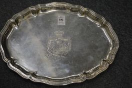 A Continental shaped oval silver salver with engraved armorial.