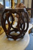 A Chinese hardwood pierced barrel shaped stand.