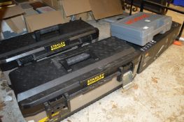 A Bosch cordless drill, two work boxes containing various tools, a trolley jack and other items.
