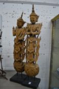 A pair of carved wood Thai standing figures.