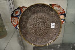 A relief cast classical style bronze circular plaque.