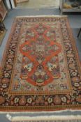 A good Persian floral decorated carpet 220cm x 138cm.