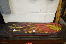 An Activision skateboard shaped electronic game.