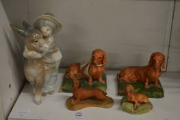 Capodimonte porcelain models of dachshund's, together with a Lladro figure of a boy and donkey.