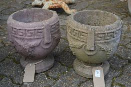 A pair of small composite garden planters.