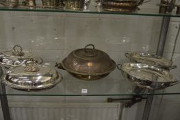 A pair oval silver plated entree dishes and covers, two serving dishes and a food warming dish.