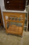 A marble top hardwood kitchen trolley.