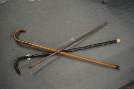 Three various walking sticks.