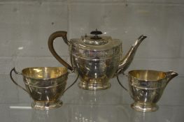 A good silver three piece tea service of oval form with a border of engraved swags and ribbons.