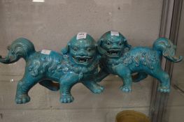 A pair of Chinese style turquoise glazed lion dogs.