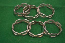 A set of six chain link style plated napkin rings.