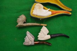 Four various meerschaum pipes.