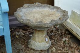 A shell shaped bird bath.
