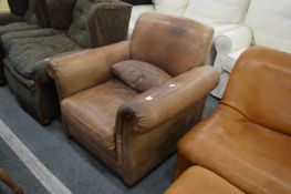 An Italian brown leather upholstered armchair.