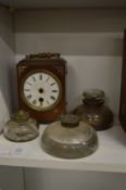 Glass inkwells and a small clock.