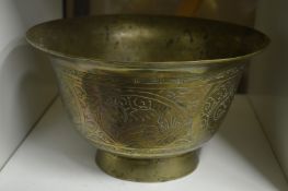 An Eastern engraved brass pedestal bowl.