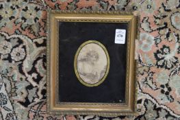 An oval engraving of a young lady in verre eglomise frame.