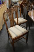 A pair of hepplewhite style mahogany dining chairs.