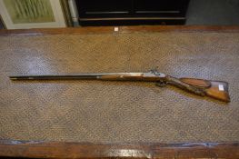 A German double barrelled percussion sporting gun, 18 bore with well carved stock depicting a deer.