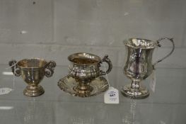 A Continental silver cup and silver with embossed decoration together with a pedestal jug and an