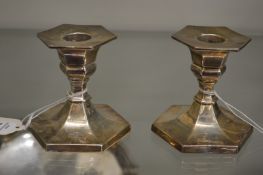 A pair of silver hexagonal shaped candlesticks.