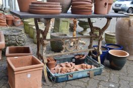 A slate topped garden table with cast iron base.