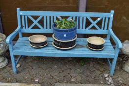 A blue painted garden bench.