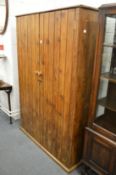 A large pine two door cupboard.
