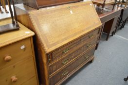 A George III oak and mahogany banded bureau.