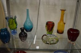 Colourful art glass vases and dishes.