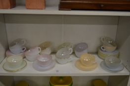 A quantity of opaque glass cups and saucers.