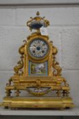 A good French ormolu mantle clock with porcelain panels, the dial signed by the retailer John