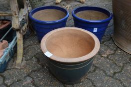 A pair of blue glazed plant pots and a similar pot.