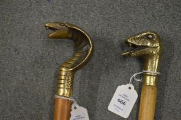 Two walking sticks, the brass handles modelled as snakes heads.