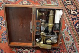 A mahogany cased brass microscope.