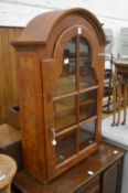 A Dutch style walnut dome top hanging display cabinet.